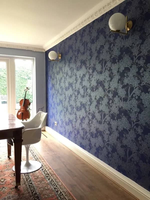 Deep blue floral feature wallpaper in a music room