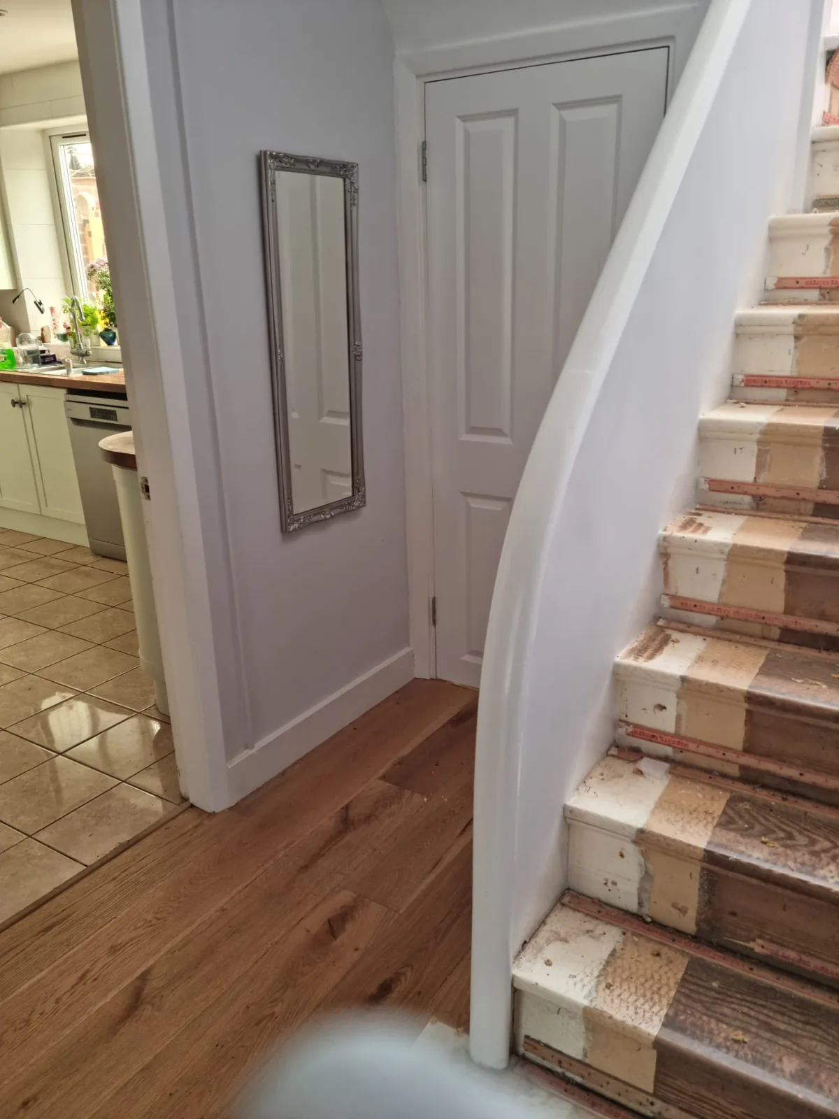 Freshly decorated hallway with mirror, staircase and woodwork