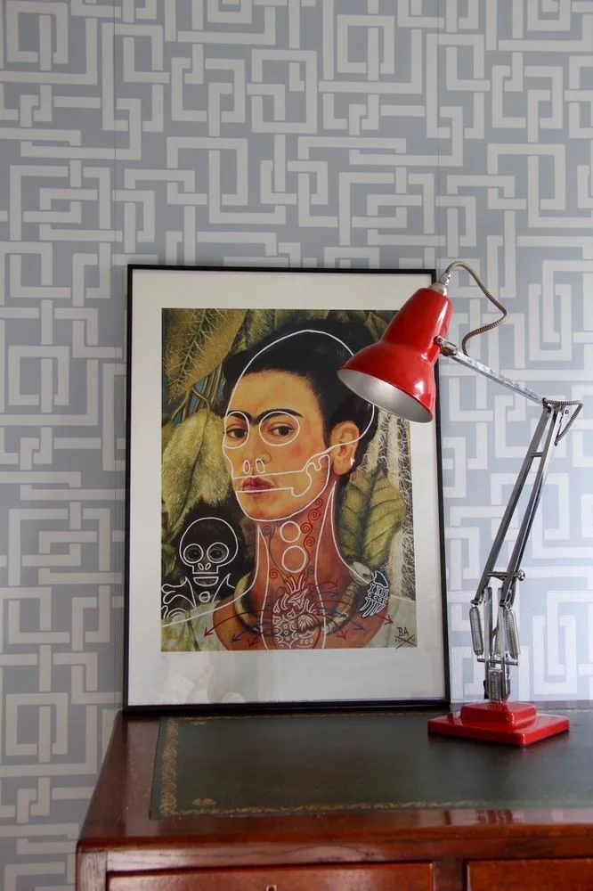 Geometric feature wallpaper behind a sideboard and framed print