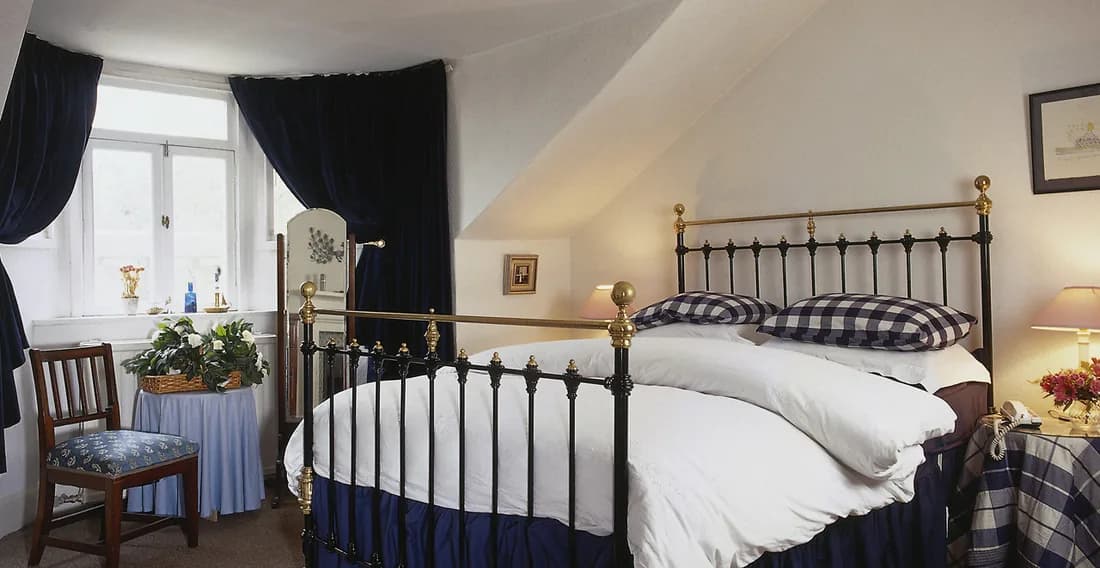 Cosy bedroom decorated in deep, moody tones