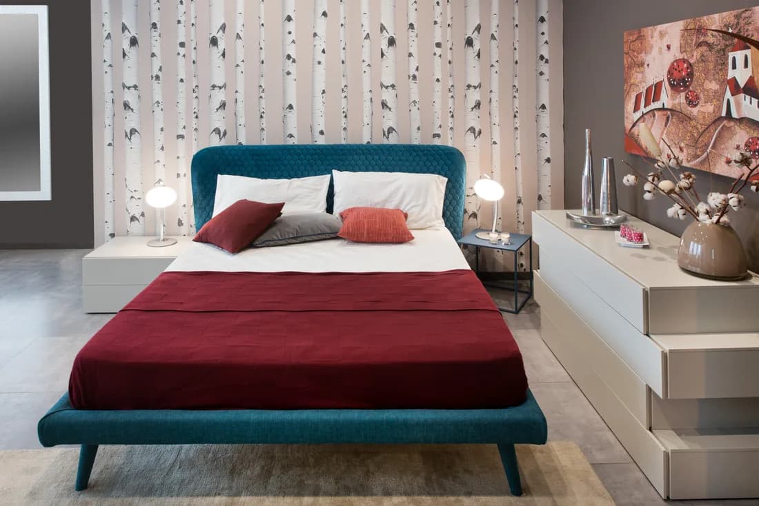 Bedroom with a large-scale patterned feature wall behind the bed